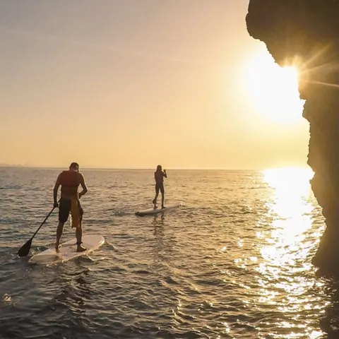 Stand up paddleboarder at sunrise near Ponta da Piedade