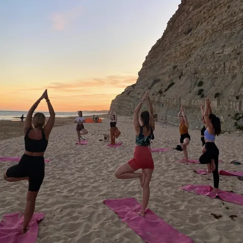 Yoga class on the beach at sunset in Lagos